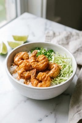 Bang bang shrimp bowl with crispy shrimp over rice on white plate