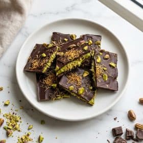 Dubai chocolate bark with pistachio filling and crispy pastry on white plate