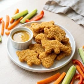 Homemade dinosaur shaped chicken nuggets with honey mustard dip