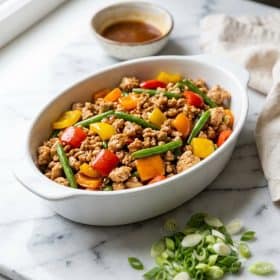 Ground chicken stir fry in a white dish