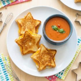 Star shaped grilled cheese sandwiches on a white plate