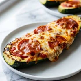 Close-up of zucchini pizza boat with bubbly melted cheese and pepperoni